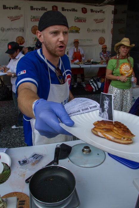 John Basset sends out his sandwich, called the 'Papa Morton', at the Last Grilled Cheese Invitational at the Los Angeles Center Studios on Saturday April 12, 2014.  